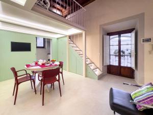 a dining room with a table and chairs and a staircase at Luxury apartment SS Annunziata in Florence