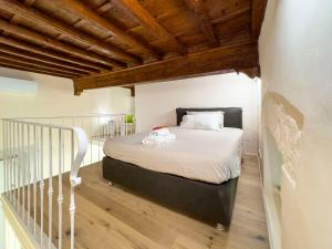 a bedroom with a bed in a room with wooden ceilings at Luxury apartment SS Annunziata in Florence