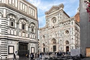 a group of people walking in front of a cathedral at Luxury apartment SS Annunziata in Florence