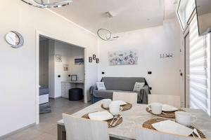 a dining room and living room with a table and chairs at Residenza Il Castello, Cervia. in Cervia