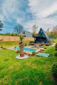 a home with a swimming pool and a house at KAYA PALACE SAPANCA in Sapanca