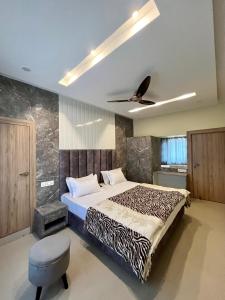 a bedroom with a bed and a ceiling fan at Shomaan boutique hotel in Sundarnagar