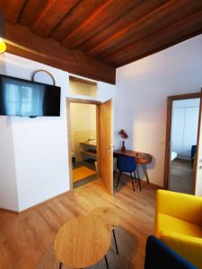 a living room with a yellow couch and a table at Gasthof zur Sonne in Übelbach