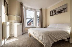 a bedroom with a bed and a large window at The Boat House Sleeps 4 Pet Friendly in Dawlish