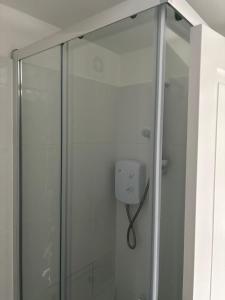 a shower with a glass door in a bathroom at Comfort Zone in Colchester