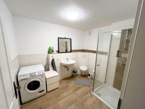 La salle de bains est pourvue d'un lave-linge et d'un lavabo. dans l'établissement Nice Apartment in Düren, à Düren