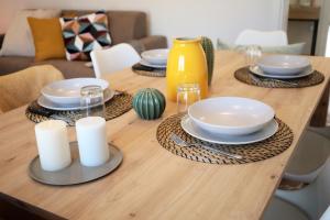 a wooden table with plates and dishes on it at Tuscany Best Point [Stazione] in Montale