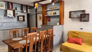 a dining room with a table and chairs and a couch at Casa di Giovanni - Italien in Muggia