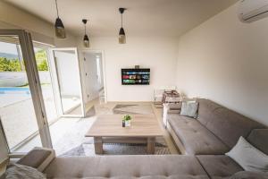 ein Wohnzimmer mit einem Sofa und einem Tisch in der Unterkunft Villa Green in Mostar