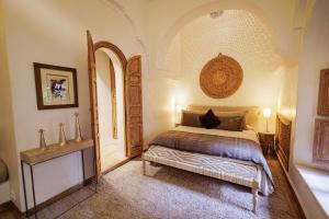 a bedroom with a bed and an arched doorway at La Villa Nomade in Marrakech