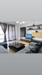 ein Wohnzimmer mit einem Sofa und einem Couchtisch in der Unterkunft Panoramic Apartment Amelia in Sarandë