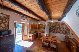 a kitchen with a table and a dining room at Casale Gelsi in Maiori +28 photos
