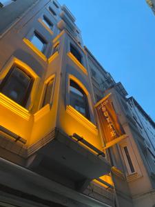 a yellow building with a sign on the side of it at Alyon Suite Hotel Taksim in Istanbul