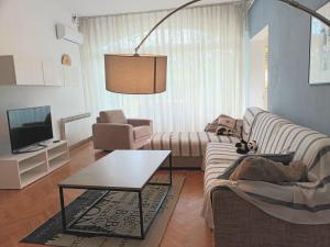 a living room with two couches and a coffee table at Jane's Garden in Matulji