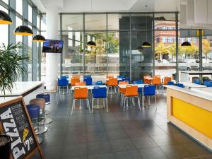 a dining room with tables and chairs in a restaurant at ibis Budget Manchester Centre Pollard Street in Manchester