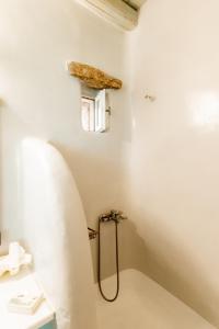 a bathroom with a shower and a sink at Honey Bee House in Mikonos