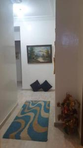 a hallway with a rug and a painting on the wall at Beautiful apartment in the city center in Casablanca