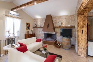 a living room with a white couch and a fireplace at Villetta tra Mari e Monti by BarbarHouse in San Giovanni Rotondo