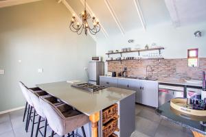 a kitchen with a counter top and a brick wall at Berg River Living in Velddrif