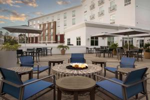 d'une terrasse avec des tables, des chaises et un foyer extérieur. dans l'établissement Hilton Garden Inn Charleston / Mt. Pleasant, à Charleston