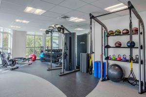 a gym with a lot of equipment in a room at Hilton Garden Inn Charleston / Mt. Pleasant in Charleston