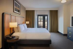 a hotel room with a large bed and a television at DoubleTree Suites by Hilton Lexington in Lexington