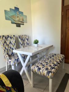 a white table and two chairs with a white table at White palms apartment in Mombasa