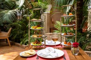 a table with plates of food and glasses of wine at La Villa Nomade in Marrakech