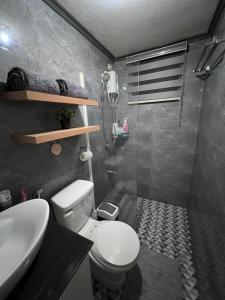 y baño con aseo, lavabo y ducha. en One Oasis Cozy condo beside Sm Ecoland en Dávao