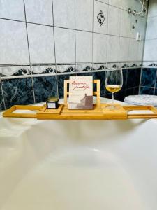 a wooden shelf with a glass of wine and a sign at Apartman Latice in Tomislavgrad +44 photos