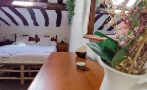 a room with a table and a bed in the background at Casa Rural Casa Selmo in Carreno