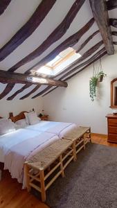 a bedroom with a large bed and a wooden ceiling at Casa Rural Casa Selmo in Carreno