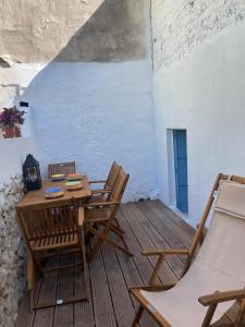 a wooden table and chairs on a wooden deck at La casita Azul in Cazorla