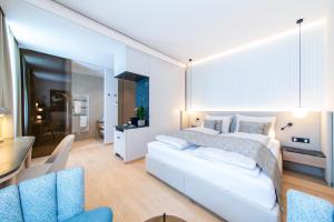 Voodi või voodid majutusasutuse Apollo AchtQuartier Das Hotel am Mondsee toas