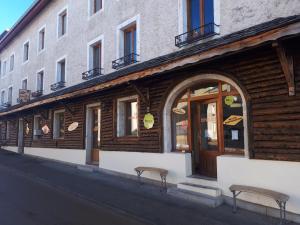 a store with two chairs in front of a building at Le Chalet Lamoura Haut-Jura in Lamoura