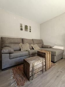 a living room with a couch and a coffee table at Alojamiento Rural El Cerro in Fresneda de la Sierra