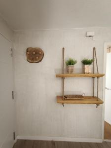 a room with two wooden shelves on the wall at Alojamiento Rural El Cerro in Fresneda de la Sierra