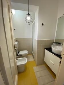 La salle de bains est pourvue d'un lavabo, de toilettes et d'un miroir. dans l'établissement LA TERRAZZA DI MARTA, à Porto Empedocle