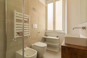 a bathroom with a toilet and a sink and a shower at Domus Eroi in Rome +24 photos