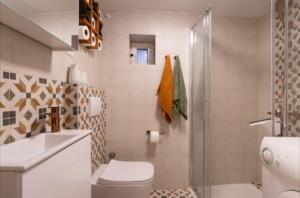 a bathroom with a shower and a toilet and a sink at de qua de la studio in Rovinj