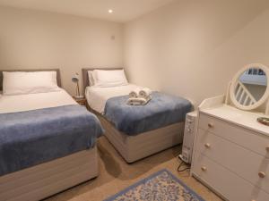 a bedroom with two twin beds and a mirror at 16 Church Street in Lyme Regis