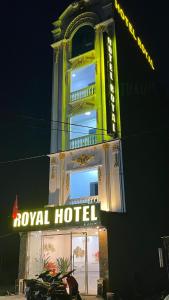 a hotel with a neon sign in front of a building at Royal Hotel Vĩnh Phúc in Vĩnh Phúc