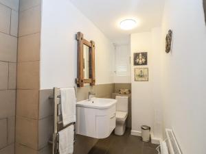 a white bathroom with a toilet and a sink at 16 Church Street in Lyme Regis +19 photos