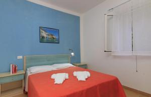 a bedroom with a bed with two towels on it at Charming Studio in Vieste, 25 m², Shared Pool in Vieste