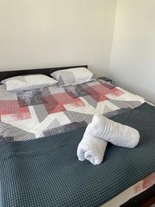 a bed with two white socks sitting on it at Apartament Orșova Faleză in Orşova