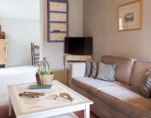 a living room with a couch and a coffee table at Apartamento Azul in Revilla de Cepeda