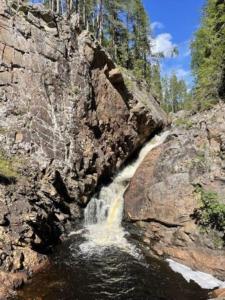 a waterfall on the side of a rocky mountain at Utsikten - Ny flott hytte, Privat Badstue, Spabad! in Torsby