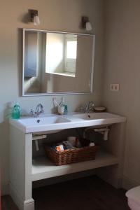 a bathroom with a white sink and a mirror at Apartamento Coral in Revilla de Cepeda