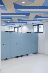 a room with a blue ceiling and white cabinets at SAGA 307 in Jagodina