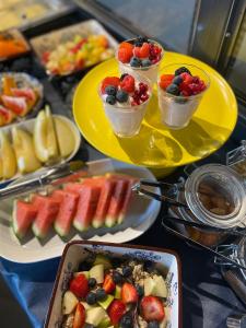 a table topped with plates of fruit and desserts at Hotel De Gravin in 's-Gravenzande
